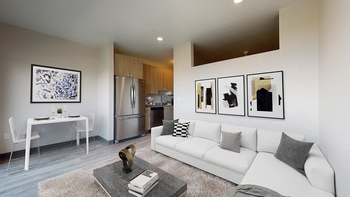 A modern living room with a white couch and a coffee table.